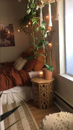 a bedroom with a bed, plant and lights on the wall above it's headboard