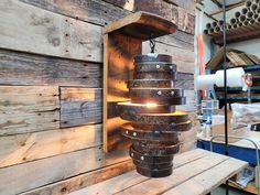 a light that is on top of a wooden shelf in front of a wood wall