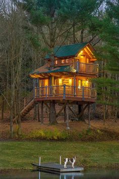 a tree house lit up at night in the woods