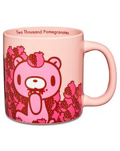 a pink coffee mug with a cartoon bear on the front and two thousand pomegranates on the back