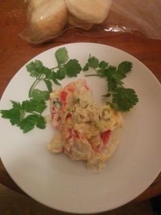 a white plate topped with food and garnished with cilantro