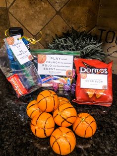 some oranges are sitting on a counter top next to other food and drink items