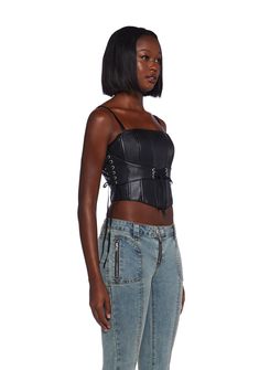 This corset top has a vegan leather construction with structured boning, an attached lace-up underbust design, adjustable shoulder straps, a curved hem, and a back zipper closure. Black Punk Corset With Straps, Black Punk Style Corset With Straps, Black Underbust Corset Belt With Straps, Black Overbust Corset With Adjustable Straps, Black Overbust Corset Belt With Straps, Punk Style Underbust Corset Belt With Corset Back, Gothic Corset With Straps, Black Corset With Tank Straps, Black Corset With Tank Straps And Corset Back