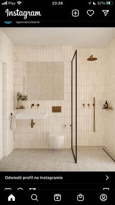 a bathroom with a toilet, sink and shower stall in the middle of the room