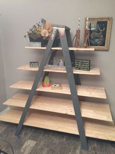 a wooden shelf with some books on it and two ladders in front of it