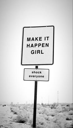 a street sign that says make it happen girl and shock everyone is on the road