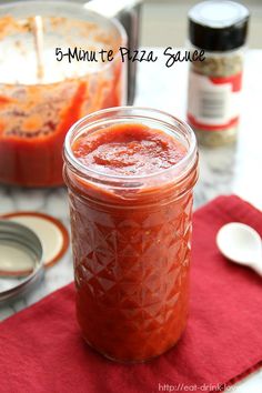 a jar filled with sauce sitting on top of a table