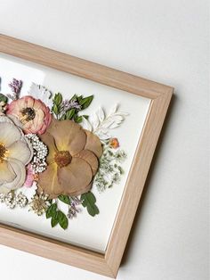 an image of some flowers in a frame