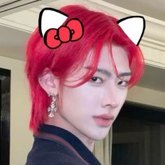 a man with red hair and cat ears on top of his head is looking at the camera