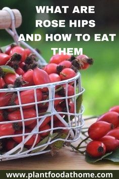 a basket filled with red berries sitting on top of a wooden table