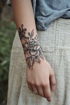 a woman's arm with a flower tattoo on it