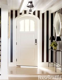 a white door with black and white striped walls