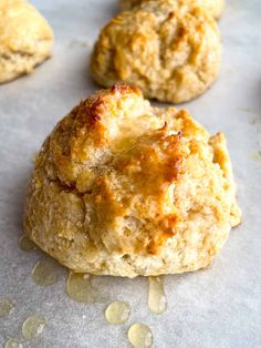 three biscuits are sitting on a baking sheet