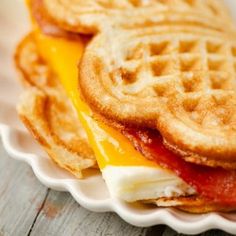 a waffle sandwich with bacon and cheese on it