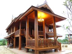 a large wooden house sitting on top of a sandy beach