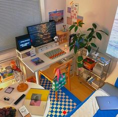 a room with various items on the floor and in front of a computer screen that is turned on