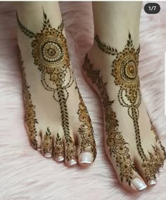 the feet are decorated with henna designs