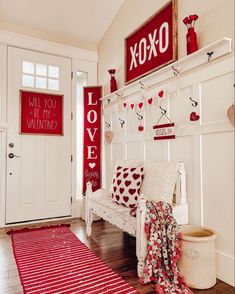 a red and white valentine's day entryway with love signs on the wall