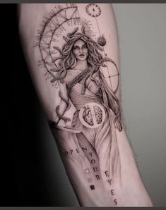 a woman's arm with a clock and compass tattoo on the left inner arm