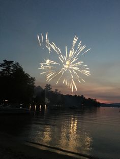 fireworks are lit up in the sky over water