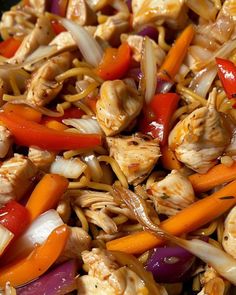 chicken, carrots and onions are mixed together in a wok with some seasoning