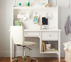 a white desk and chair in a child's room with toys on the shelves