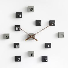 a clock made out of metal cubes with numbers on each side and two hands