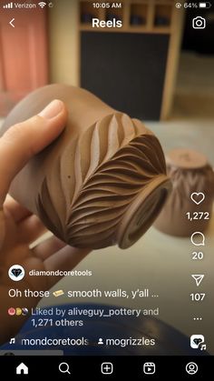 someone is holding a chocolate covered item in their hand and it looks like they are making something