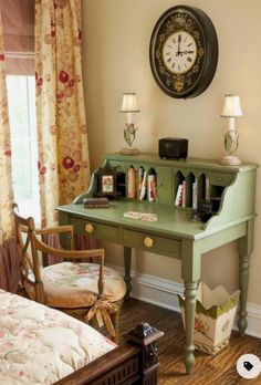 a bedroom with a green desk and clock on the wall