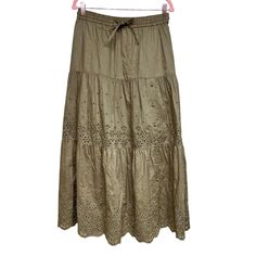 Elevate Your Wardrobe With This Stunning Coach Broderie Anglaise Long Skirt. The Skirt Is Made From High-Quality Cotton Fabric, Ensuring Comfort And Durability. The Drawstring Closure Adds A Touch Of Elegance, Making It Perfect For Any Occasion Such As Parties, Casual Outings, And Even Business Meetings. The Skirt Comes In A Beautiful Dark Olive Green Color And Features Intricate Embroidery Details With Button Accents. It Has A Mid-Rise And A Maxi Length, Making It A Classic Piece For Any Wardro Long Floral Skirt, Eyelet Skirt, Long Skirts For Women, Dark Olive Green, Olive Green Color, Intricate Embroidery, Tier Skirt, Embroidery Details, Green Fashion