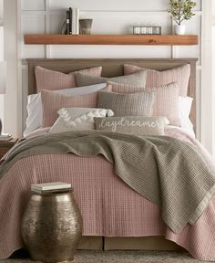 an image of a bed with pink comforter and pillows on the bottom right side