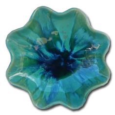 a blue flower shaped glass dish on a white background