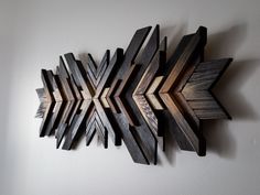 a wooden wall decoration with an arrow on it