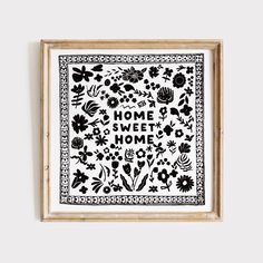 a black and white print with the words home sweet home on it in a wooden frame