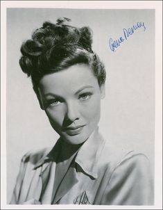 an old black and white photo of a woman with her hair in a bun hairstyle