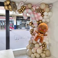 an assortment of balloons in the shape of a gingerbread man and candy canes