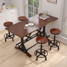 a kitchen table with four stools in front of it