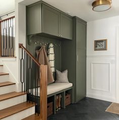 an entryway with stairs and storage boxes