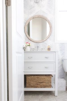 a bathroom with a mirror, sink and toilet