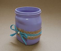 a purple jar with a blue ribbon around it