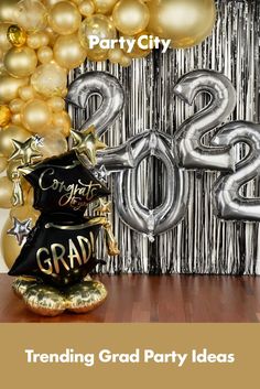 graduation party decorations with balloons and streamers in front of the number twenty two sign