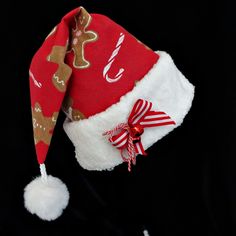 a red and white christmas hat with gingerbreads on it