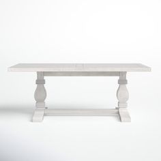 a white table sitting on top of a wooden floor