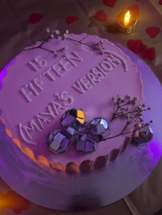 a birthday cake with purple frosting and decorations