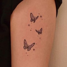 three butterflies flying in the sky with stars on their backs