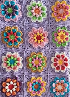 a crocheted blanket with many colorful flowers on it