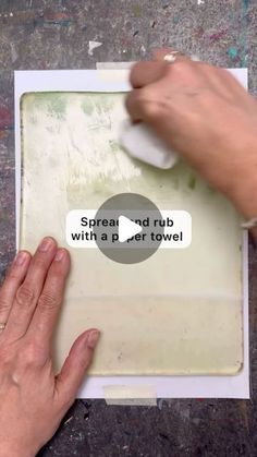 a person using a paper towel on top of a piece of paper with the words spread and rub with a paper towel