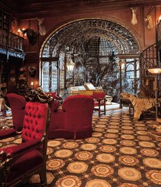 an ornately decorated living room with red chairs