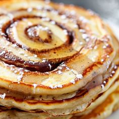 a stack of pancakes covered in powdered sugar