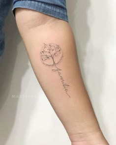 a woman's arm with a flower tattoo on it